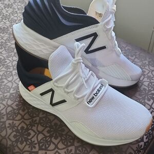 Men's New Balance white sneakers.